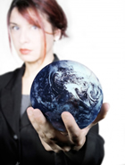 Corporate woman holding the world in her hand